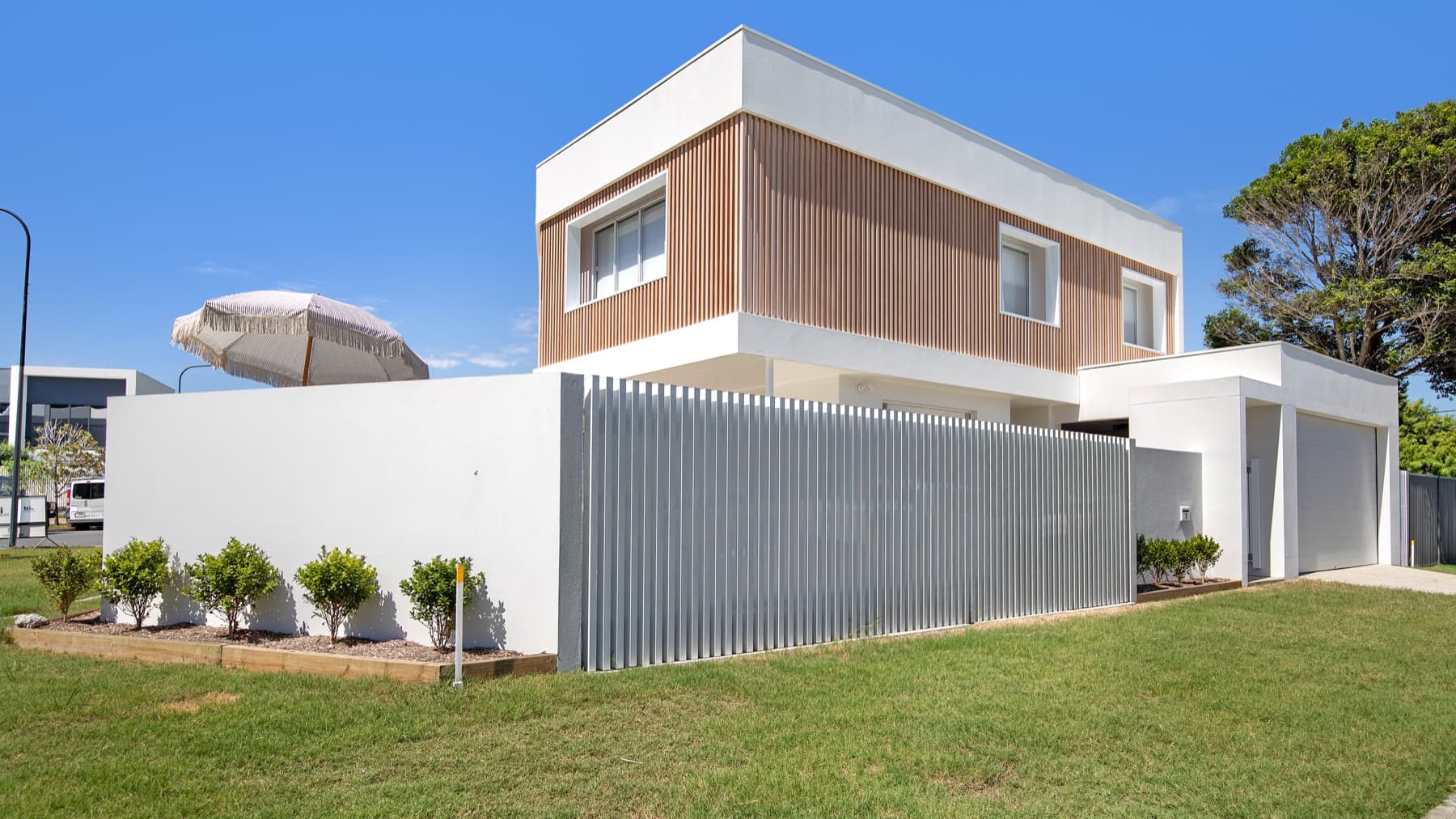 Modern white home exterior repainted by Two Bros Painting