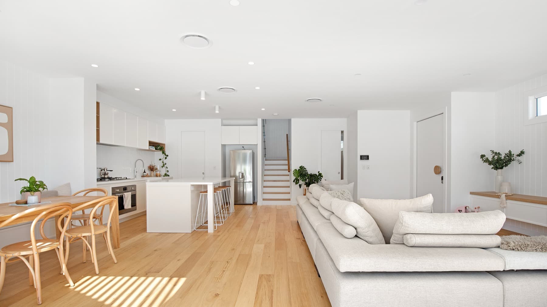 Freshly painted white open-plan living and kitchen in a Melbourne home